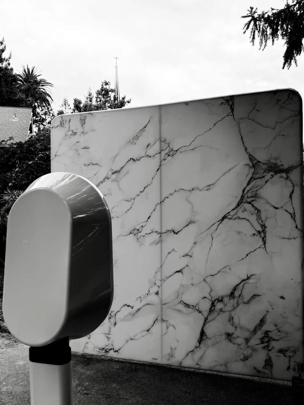 Black-and-white photo of the Look at You booth against its marble backdrop