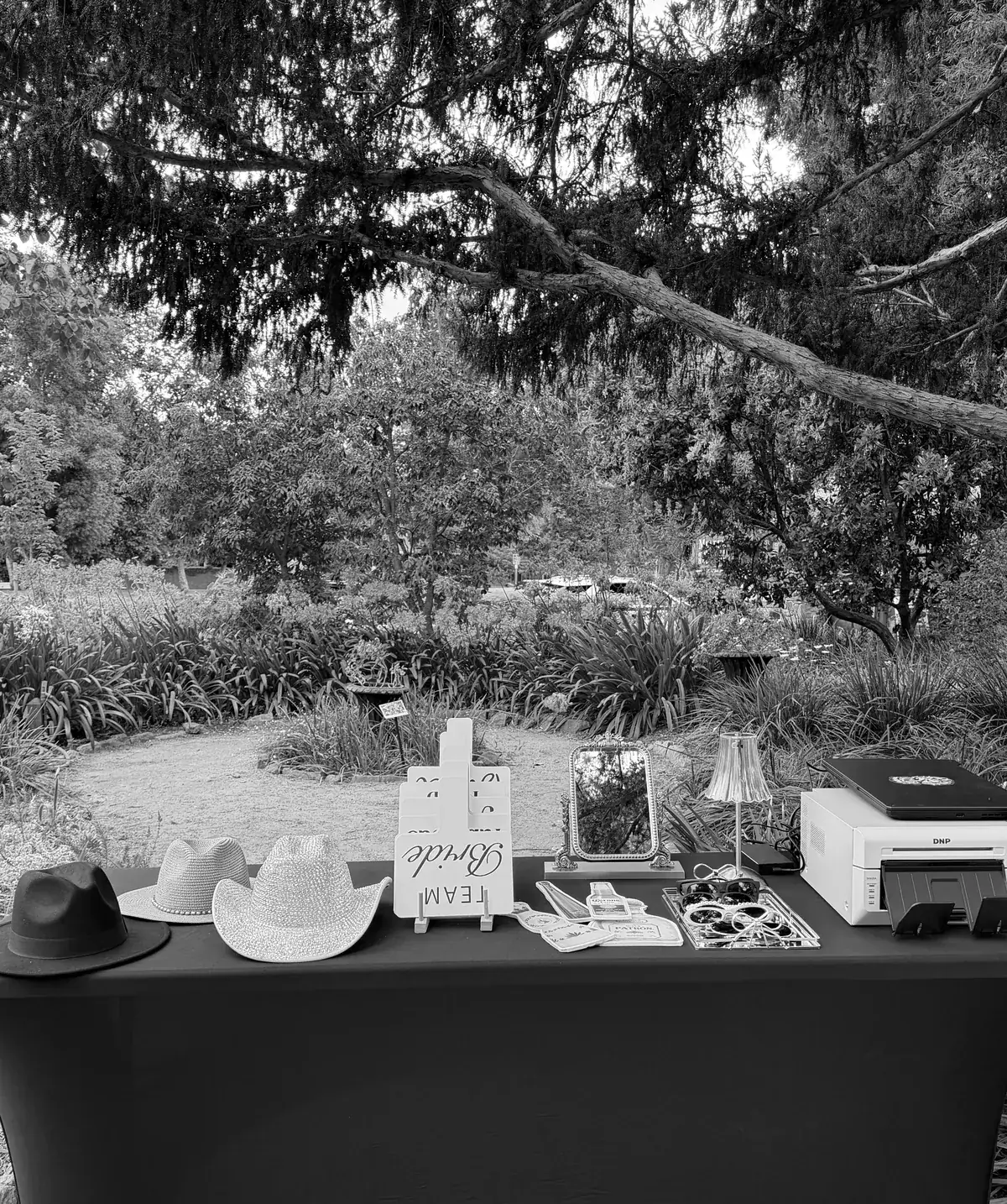 Black-and-white photo of the Look at You setup table in a garden setting